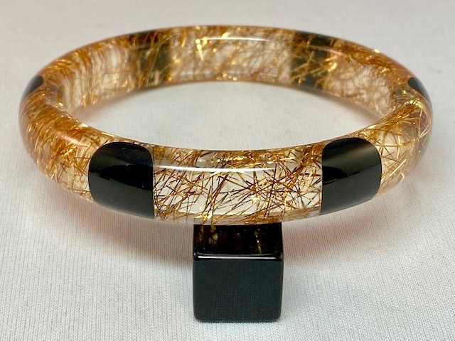AB127 clear lucite/gold tinsel bangle with black bakelite dots
