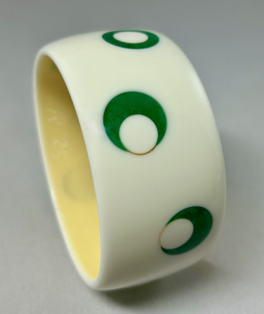 AP24 wide white with green googly eyed dots bakelite bangle