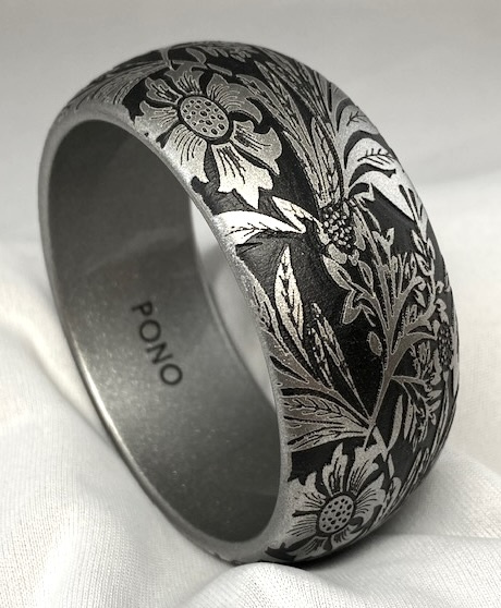 Signed PONO silver and black etched flowers resin bangle measures 1 3/16" wide X 2 9/16" wrist openi