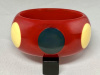 AB126 Pantti wide red bakelite bangle with cream and blue grey dots