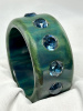 Double rope carved bakelite bangle by Brad Elfrink in rare marbled red and khaki color. The bangle i